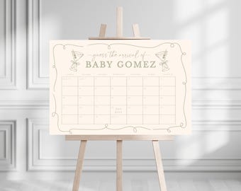 May include: A cream-colored sign on a wooden easel with the text "guess the arrival of BABY GOMEZ" and a calendar grid. The sign has a decorative border and two cocktail illustrations. The easel is made of light-colored wood.