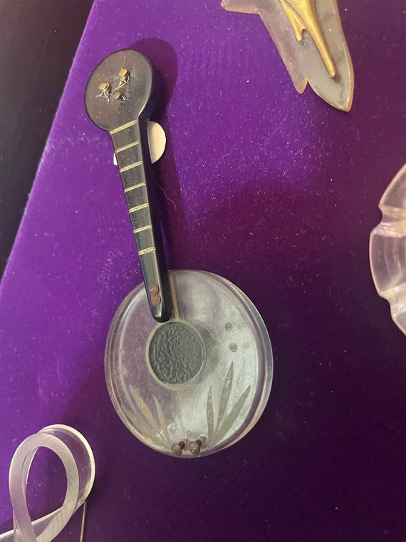 Cute lil’ lucite banjo brooch!