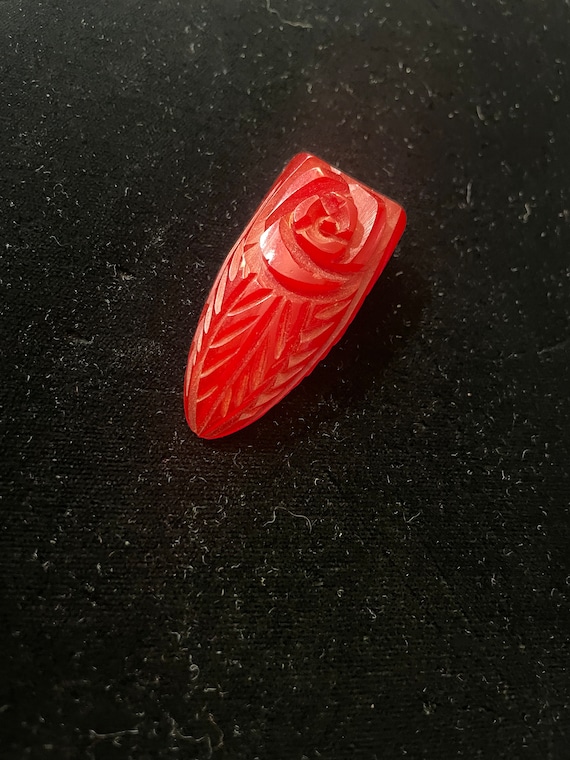 Wonderful cherry red carved Bakelite dress clip