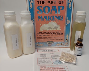 May include: A soap-making kit with bottles of palm oil and coconut oil, a bottle of olive oil, and almond flavor. The kit includes a bag of oatmeal, instructions, and a decorative sign that reads "The Art of Soap Making."