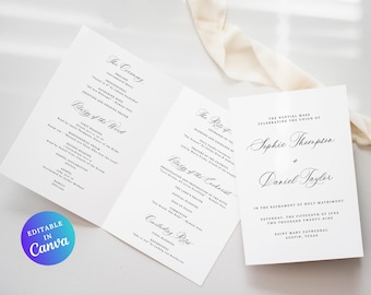 May include: A white wedding program with elegant calligraphy. The program is open, displaying the ceremony details, and a separate card features the names Sophie Thompson and Daniel Taylor, along with the wedding date.