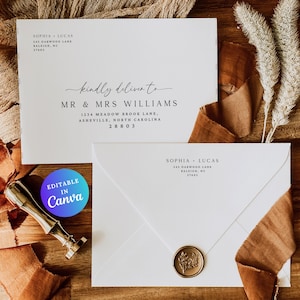 May include: Two white envelopes with elegant calligraphy, one addressed to Mr. & Mrs. Williams. A gold wax seal and a gold stamp are visible. The text "Editable in Canva" is on a blue and purple circle. Brown fabric and dried plants are in the background.