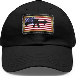 May include: A black baseball cap with a gold-framed patch featuring an American flag with a silhouette of a rifle.