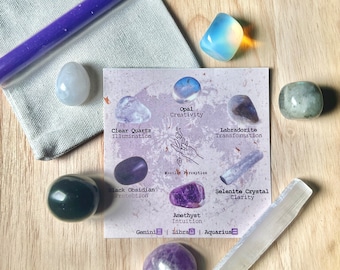 May include: A set of crystals and a selenite wand on a wooden surface. The crystals are labeled with their names and properties: Opal, Creativity; Clear Quartz, Illumination; Labradorite, Transformation; Black Obsidian, Protection; Amethyst, Intuition; Selenite Crystal, Clarity. The text also includes the zodiac signs associated with each crystal: Gemini, Libra, Aquarius.