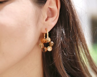 May include: Gold hoop earrings with a circle of brown and gold tiger's eye beads.