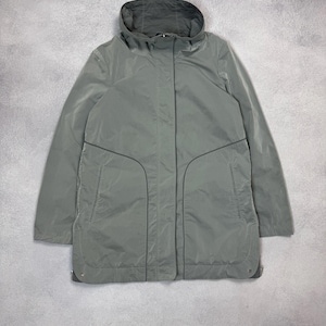 May include: A light green, hooded jacket with a full-length zipper and two front pockets. The jacket has a simple, streamlined design and is made of a lightweight material. The jacket is a solid color and has a casual style.
