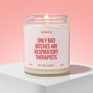 May include: A clear glass jar soy wax candle with a white label featuring the red text LOOMWICKS, ONLY BAD BITCHES ARE RESPIRATORY THERAPISTS, 9 OZ, and 60 H. The candle has a visible flame and is filled with white wax, presented in a simple container.