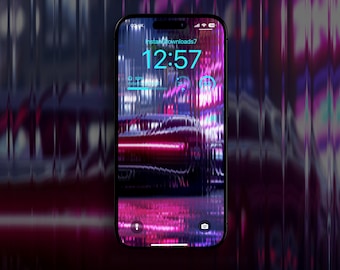 May include: A black smartphone displays a neon-lit cityscape wallpaper with a car. The screen shows the time 12:57 and the username "insta.downloads7". The phone has a black border and a glossy screen.