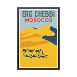 May include: A framed travel poster featuring the words "ERG CHEBBI MOROCCO" in blue and red. The image depicts a desert scene with yellow sand dunes, a blue sky, and silhouettes of camels and a person.