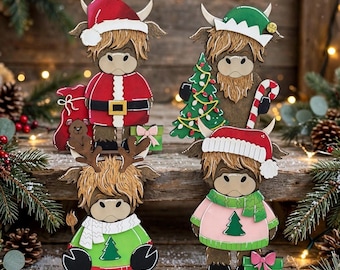May include: Four decorative wooden highland cow figures featuring holiday themes. One wears a Santa suit, one an elf hat with a tree and candy cane, one reindeer antlers with a green sweater, and one a pink sweater with a Santa hat and gift.