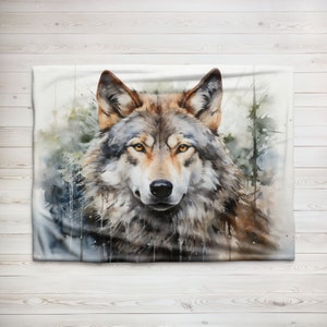 May include: A watercolor painting of a wolf's face. The wolf has a light brown and gray coat with yellow eyes. The background is a blurry watercolor of a forest.