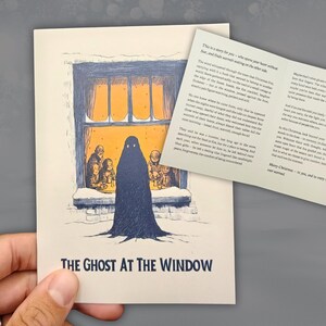 May include: A Christmas card with an illustration of a ghost outside a window, with a family inside. The card reads "THE GHOST AT THE WINDOW". An insert with text is also visible, adding to the festive theme.