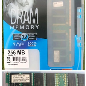May include: A 256 MB SDRAM PC133 DRAM memory module in its original blue and white packaging. The packaging features the text DRAM MEMORY, 10 YEARS WARRANTY, and 100% COMPATIBLE. The green circuit board module is visible below the packaging.