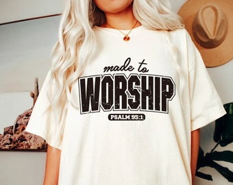 May include: A white t-shirt with a black graphic that says "made to worship" with "PSALM 95:1" underneath.