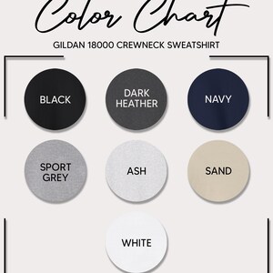 May include: Color chart for Gildan 18000 crewneck sweatshirts. The chart shows the available colors: black, dark heather, navy, sport grey, ash, sand, and white.
