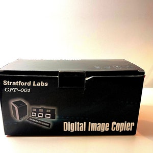 May include: A black box labeled "Stratford Labs GFP-001" with a "Digital Image Copier" logo. The box features illustrations of the copier and film slides. The background is plain white.
