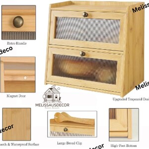 May include: A two-tiered wooden bread box with a glass front and a magnetic door. The bread box has a bamboo finish and a metal handle. The text "MELISSAUSDECOR" is printed on the front of the box.