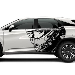 May include: A white SUV featuring a striking black and white graphic of a futuristic female face on its side. The car has black wheels and tinted windows, set against a white backdrop.