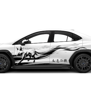 May include: White car with black detailing and wheels. A black and white graphic of a fox running across the side. Japanese text is also visible on the side of the car.