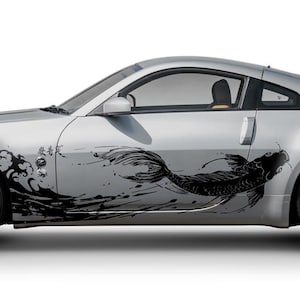 May include: Silver sports car featuring a black koi carp graphic on the side. The car has a streamlined design with black wheels and a red tail light. The koi carp design is a key feature, adding a unique aesthetic to the vehicle.