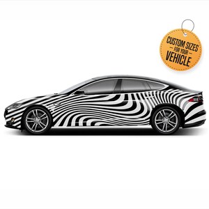 May include: A black and white zebra-striped car wrap design. The design features a wavy pattern of black and white stripes. The text "Custom Sizes - For Your Vehicle" is on a yellow tag.