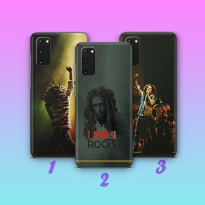 May include: Three different phone cases featuring Bob Marley. The first case has a silhouette of Bob Marley with his arms raised. The second case has a close-up of Bob Marley's face with the text "I And I Of The Roots". The third case has a photo of Bob Marley performing on stage with a microphone.