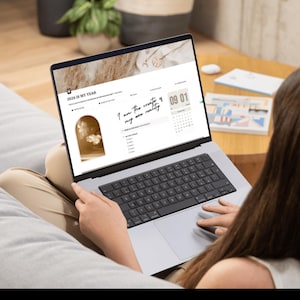 mock-up of a girl with the notion template for goal setting and vision board