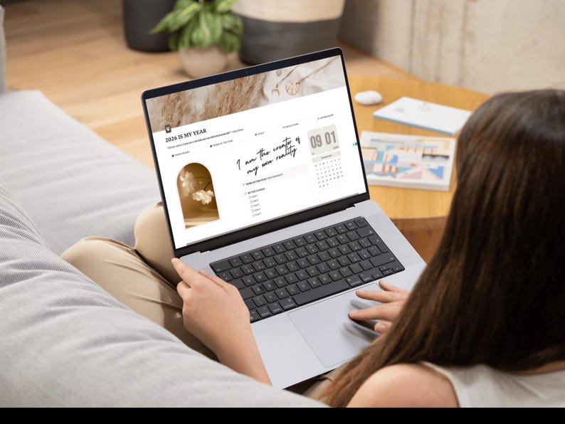 mock-up of a girl with the notion template for goal setting and vision board