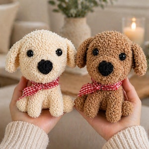 May include: Two plush dog toys, one cream-colored and one brown, are held in hands. Each has black eyes, a black nose, and a red and white checkered ribbon around its neck. The toys are made of a textured, looped fabric.