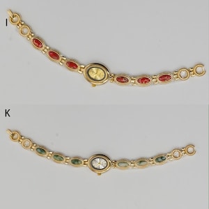 Puede incluir: Dos relojes de pulsera dorados. Uno presenta una esfera dorada y detalles de piedras rojas, el otro una esfera plateada y detalles de piedras verdes. Ambos relojes tienen esferas ovaladas y correas de eslabones dorados a juego.