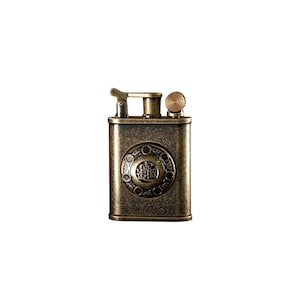 May include: A vintage-style, brass lighter with an ornate design and a small knob on the top. The lighter has a textured surface and a circular emblem with Chinese characters in the center.