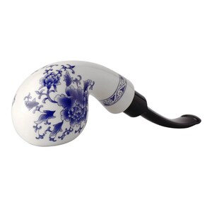 May include: A white ceramic pipe with a blue and white floral design. The pipe has a black stem.