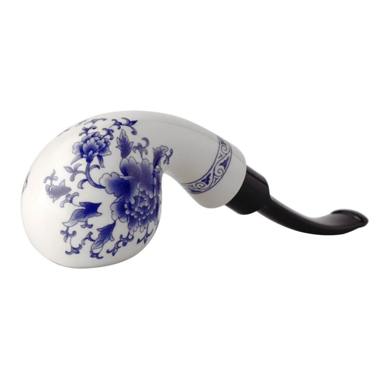 May include: A white ceramic pipe with a blue and white floral design. The pipe has a black stem.