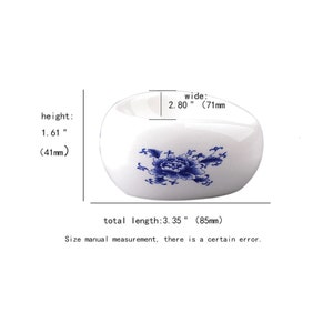 May include: White ceramic dish with a blue floral design. The dish is 3.35 inches long, 2.80 inches wide, and 1.61 inches high.