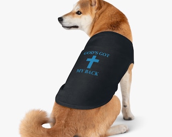 May include: A black dog vest with the text "God's Got My Back" and a blue cross.