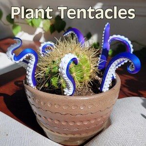 May include: A potted cactus with blue and white tentacle-shaped plant decor. The tentacles are curved and have a textured surface. The pot is brown and has a textured design. The text "Plant Tentacles" is at the top.