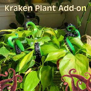 May include: Green and black Kraken plant add-on tentacles emerging from a lush green plant. The tentacles have a textured appearance with suction cup details. The text "Kraken Plant Add-on" is at the top of the image.