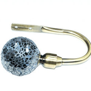 May include: Gold curtain tieback with a blue mosaic glass ball finial.