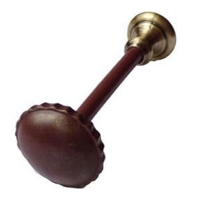 May include: A brown and gold metal curtain rod finial with a decorative, scalloped edge.