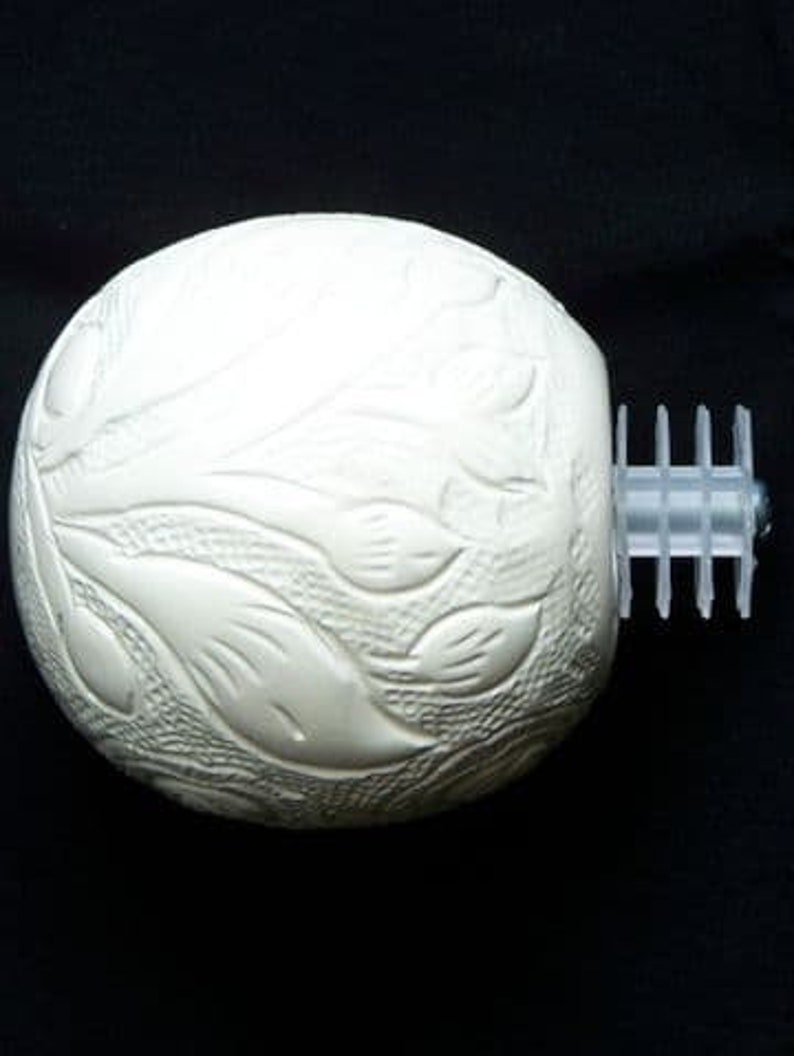 May include: White ceramic finial with a floral design. The finial has a decorative, textured surface and a smooth, white finish.