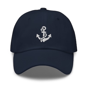 May include: A navy blue baseball cap with a white embroidered anchor design.