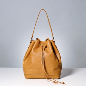 Beige leather bucket bag.