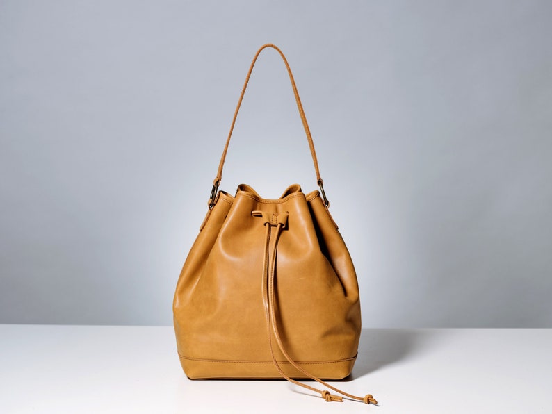 Beige leather bucket bag.