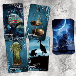 May include: A set of tarot cards with blue backgrounds and illustrations of a train, scales, a keyhole, storks, and a black cat. The cards have numbers and Russian words on them. The cards are laid out on a gray surface.