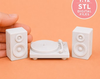 May include: A light gray 1:12 scale miniature record player and two matching speakers. The set is made of 3D printed material with a matte finish. A circular pink badge in the upper right corner displays the text 1:12 STL DIGITAL FILES.