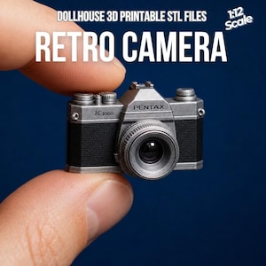May include: A miniature retro camera, labeled "Pentax K1000," is held between fingers. The camera is silver and black, with a detailed lens and the text "RETRO CAMERA" above it. The image also includes the text "DOLLHOUSE 3D PRINTABLE STL FILES" and "1:12 Scale."
