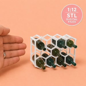 May include: A white 1:12 scale honeycomb-patterned wine rack containing eight miniature dark green bottles. The circular graphic in the corner displays the text 1:12 STL DIGITAL FILES. This item is a miniature accessory for dollhouse displays.