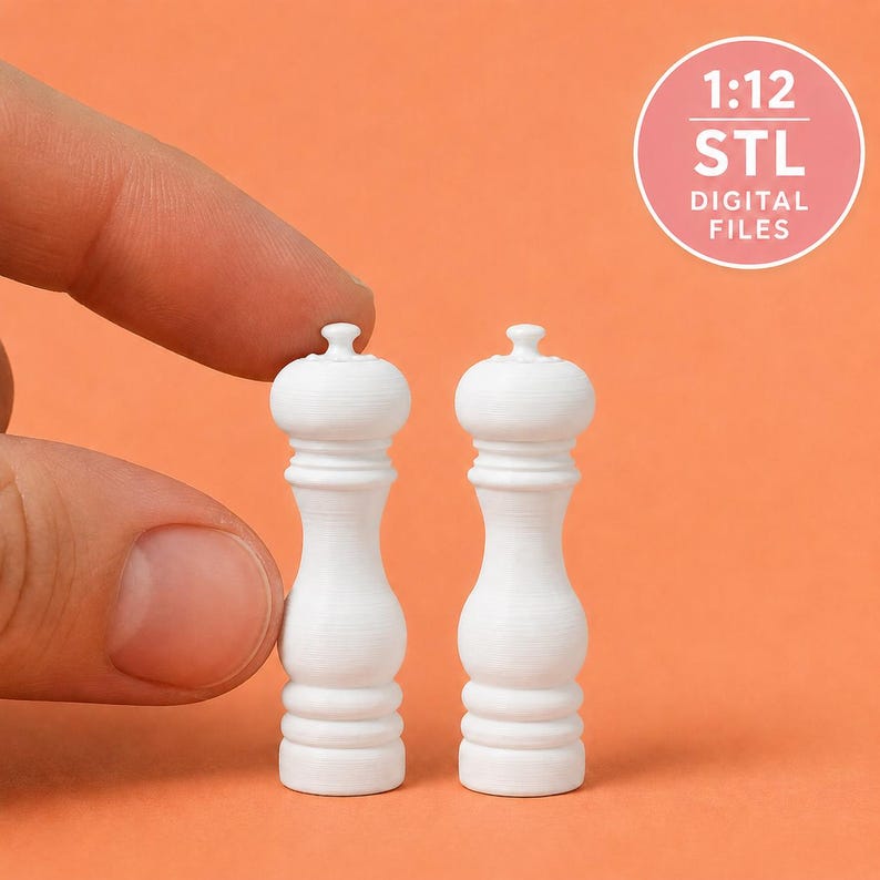 May include: Two miniature white pepper mills with a classic hourglass shape and rounded tops. The text 1:12 STL DIGITAL FILES is visible in a circular badge. These small objects feature a smooth finish and a tiered base design.