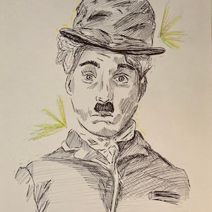 May include: A black and white pen and ink drawing of Charlie Chaplin, a famous comedian, wearing a hat and a moustache. The drawing is on a white background with yellow and green accents.