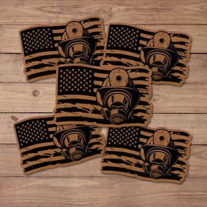 May include: A collection of stickers featuring a distressed American flag design with a firefighter's helmet and respirator. The stickers are in shades of brown and black, with the flag's stars and stripes and the helmet's details clearly visible.